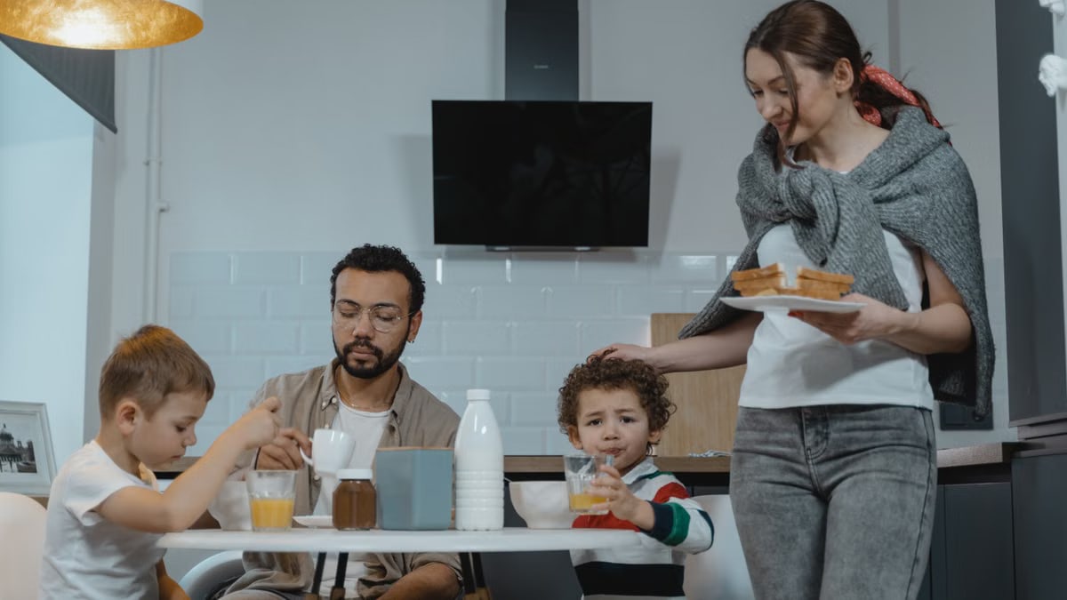 A family shares a joyful breakfast in a cozy kitchen setting, capturing a warm morning moment.